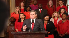 Flanked by educators dressed in red on November 8, Gov. Roy Cooper vetoed four bills that he said "prioritized more corporate tax cuts over a real teacher pay raise and urged legislators to come together and come up with a compromise."