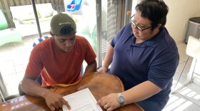 PLAYING BALL Newly arrived Venezuelan migrant Johander Sánchez (left) and his brother-in-law and sponsor Antonio Camejo in their Fontainebleu home going over the new humanitarian parole program that brought Sánchez to the U.S.