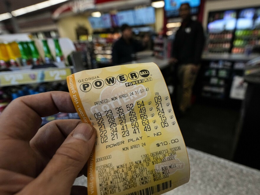 A Powerball lottery ticket is displayed seen inside a convenience store, Monday, April 1, 2024, in Kennesaw, Ga.