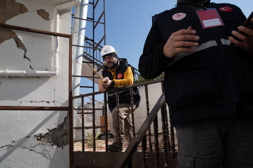 Onur Tezcan Okut, a Turkish civil engineer, stands near a damaged wall at a restaurant and wedding venue. The building looked OK at first, but there are thin cracks in the support columns in the back.