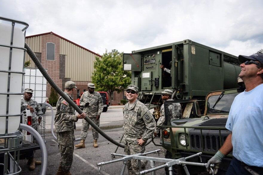 US Army Reservists help to collect and distribute water through the surrounding areas affected by the flooding.