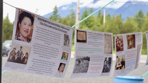 Photos of Amy Hallingstad with a detailed timeline of her life hang between two tent poles at Petersburg’s Amy Hallingstad Day celebration, hosted by Petersburg Indian Association, on June 28, 2026.