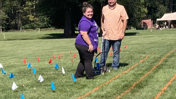Volunteers create a grid on the lawn at Montpelier to prepare for the creation of a living flag.