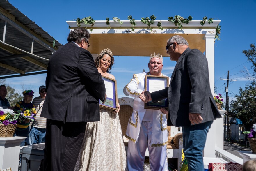 Terrebonne parish president Gordy Dove and councilman Steve Trosclair shake Krewe de Bonne Terre's King and Queen Forrest and Christina Travirca hands while presenting them with keys to the city.