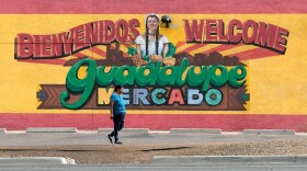 A person walks past a mural promoting Guadalupe, Ariz., May 19, 2026.