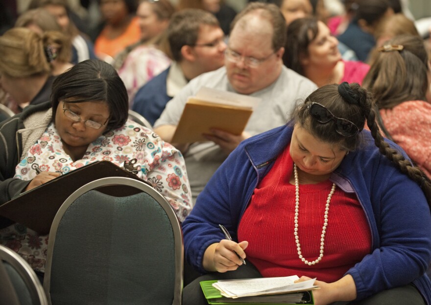 Aspiring contestants fill out applications during an open audition for <em>The Biggest Loser, Season 10</em>. More than 500 people showed up at the D.C. audition, with thousands more applying around the country.