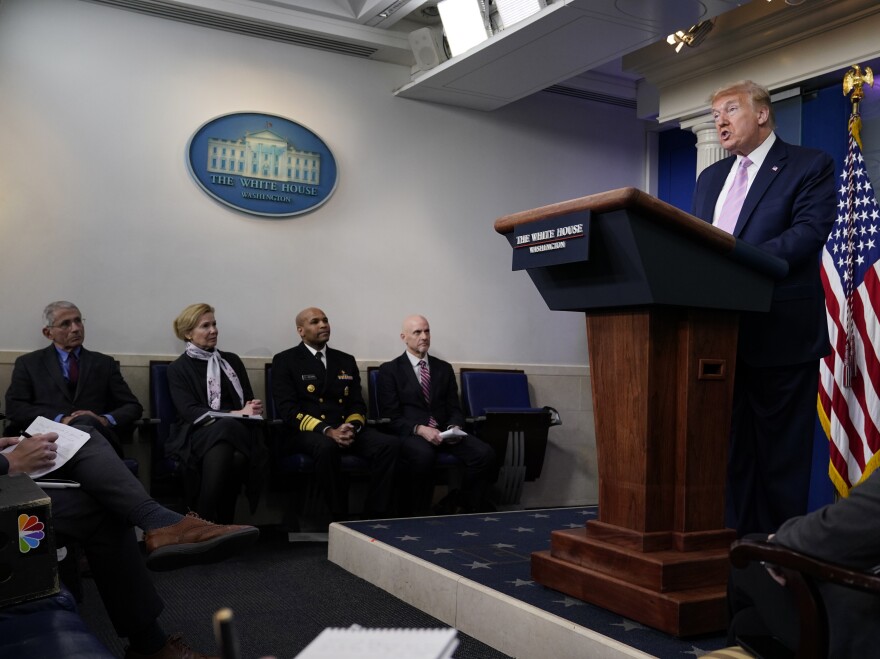 President Donald Trump speaks during a coronavirus task force briefing at the White Houseon Friday. Seated from left, Director of the National Institute of Allergy and Infectious Diseases Dr. Anthony Fauci, White House coronavirus response coordinator Dr. Deborah Birx, Surgeon General Jerome Adams, and Food and Drug Administration Commissioner Dr. Stephen Hahn.