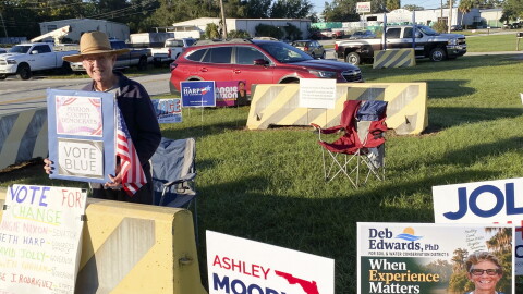 Retired high school math teacher Tom Lakin stands inside a special enclosure for campaign signs and campaigners at the Marion County Supervisor of Elections Office in Ocala on Thursday, the first day of early voting for the Nov. 3 General Election.