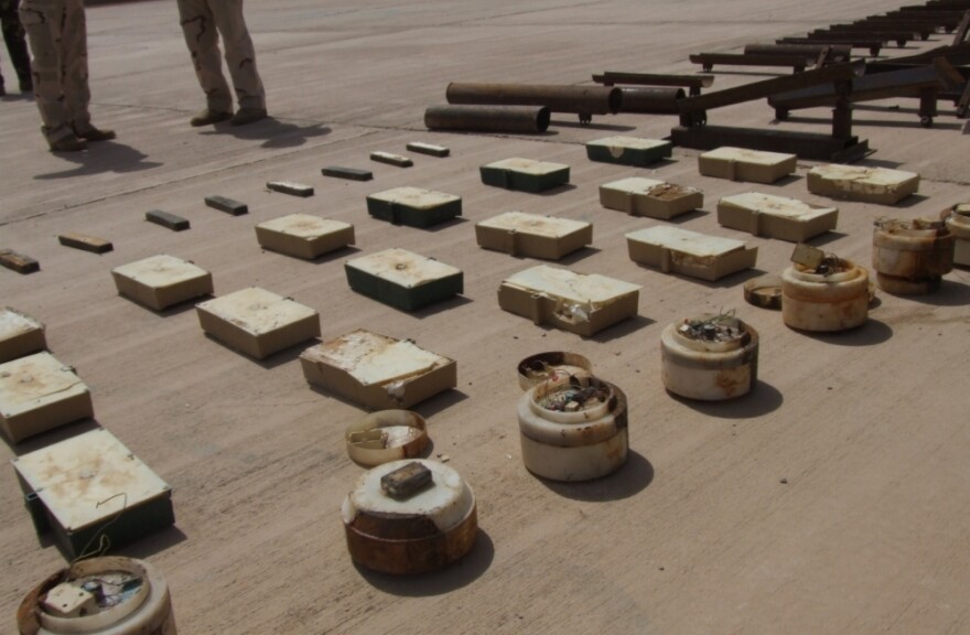 U.S. and Iraqi soldiers display "sticky IEDs"  — magnetic bombs that militants attach to vehicles — found during a raid at a checkpoint near the Iraq-Iran border.