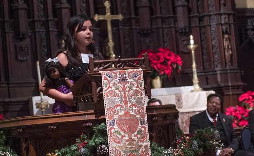 Adonia Balqis, a 10 year old fifth grader from Columbus, holds a doll that plays a role in her winning speech.