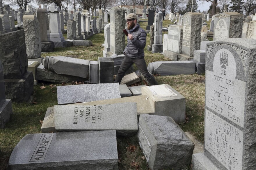 Rabbi Joshua Bolton of the University of Pennsylvania's Hillel center surveys damaged headstones at Mount Carmel Cemetery  in Philadelphia. (Jacqueline Larma/AP)