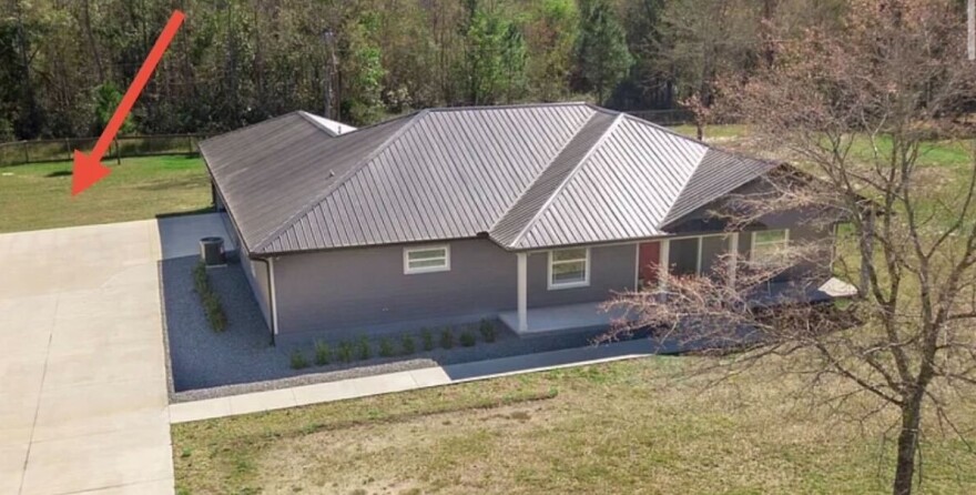 The arrow points to the location where Arcadis drilled holes into a well to sample water on the Greens’ property. (Photo courtesy of Michelle Green)