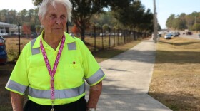 Crossing Guard Helen Hester, 84, prepares for the end of the school day outside Meadowbrook Elementary in Gainesville, Fla., on Friday, Nov. 21, 2025.