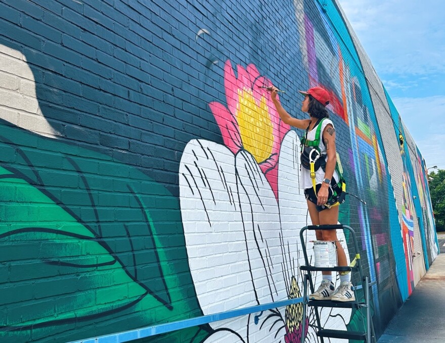 Local artist Mary Grace Tracy helped McCollum paint the mural’s surrounding details, including magnolias and camellias.