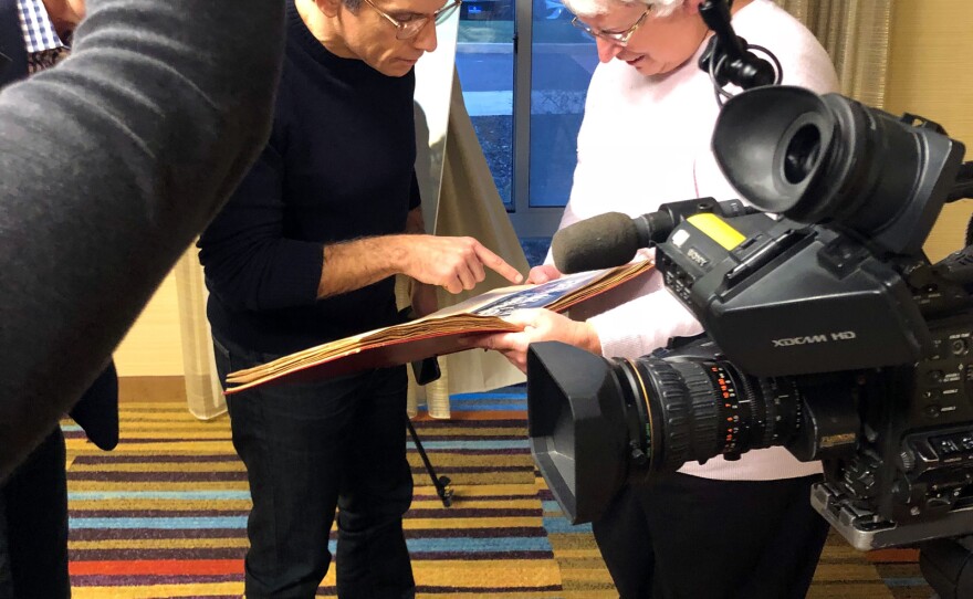 Ben Stiller looks at scrapbook kept by WAMC's Pat Bradley