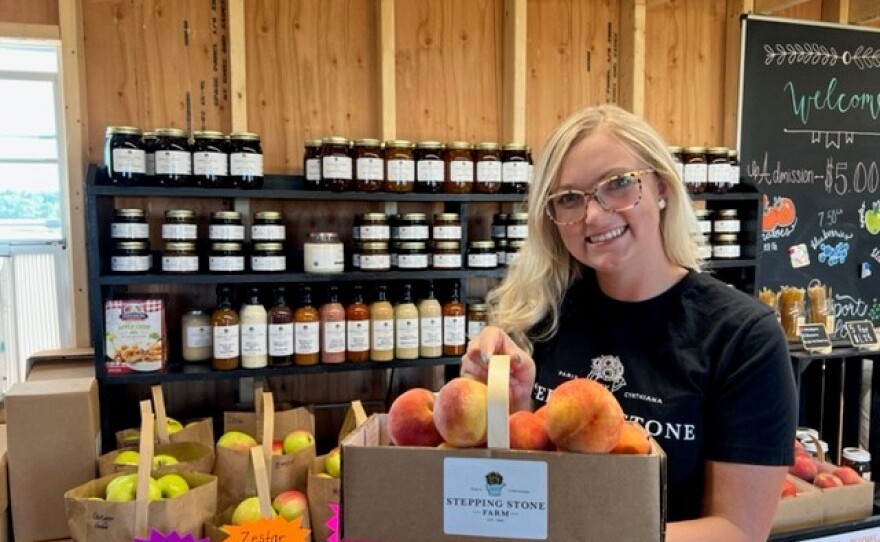 Ally Barnett with fresh peaches at Stepping Stone Farm in Bourbon County