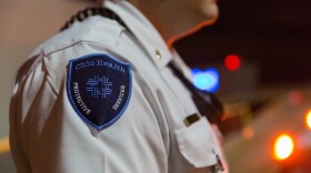 A patch on a uniform shoulder reads "Ohio Health Protective Services." 