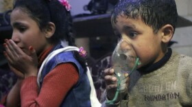 This image released early Sunday, April 8, 2018 by the Syrian Civil Defense White Helmets, shows a child receiving oxygen through respirators following an alleged poison gas attack in the rebel-held town of Douma, near Damascus, Syria. Syrian rescuers and medics said the attack on Douma killed at least 40 people. The Syrian government denied the allegations, which could not be independently verified. The alleged attack in Douma occurred Saturday night amid a resumed offensive by Syrian government forces after the collapse of a truce. (Syrian Civil Defense White Helmets via AP)