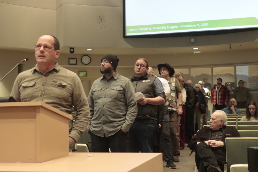 Several dozen people lined up to testify on a sales tax proposal in the Anchorage Assembly chambers on Dec. 2, 2025.