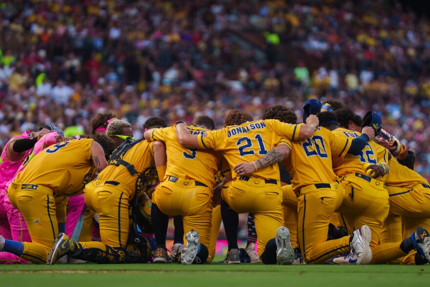 The Savannah Bananas and Party Animals pray together ahead of the baseball game between the Savannah Bananas and the Party Animals at Busch Stadium on Friday, July 18, 2025, in downtown St. Louis.