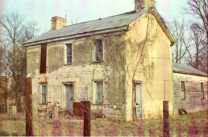 Old stone home built in 1805-1806 by Amos Rowark; purchased by Obediah Scott about 1813. Near Minnith, Missouri. Picture by family historian Lou Hudson Pellican,1985.