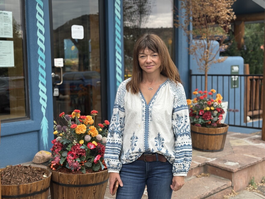Woman stands outside.
