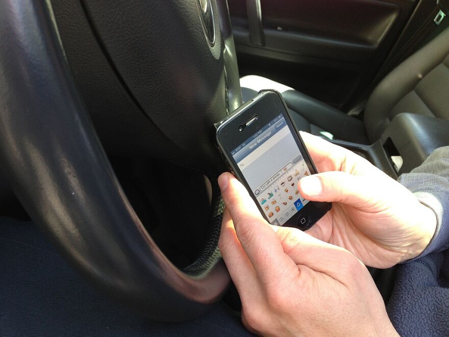 Having a phone in your hand while driving could cost you $136 under the new law.