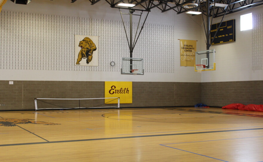 The Eveleth Community Center includes the old Eveleth-Gilbert High School gym. A bouncy house owned by the city is rolled up against the wall.