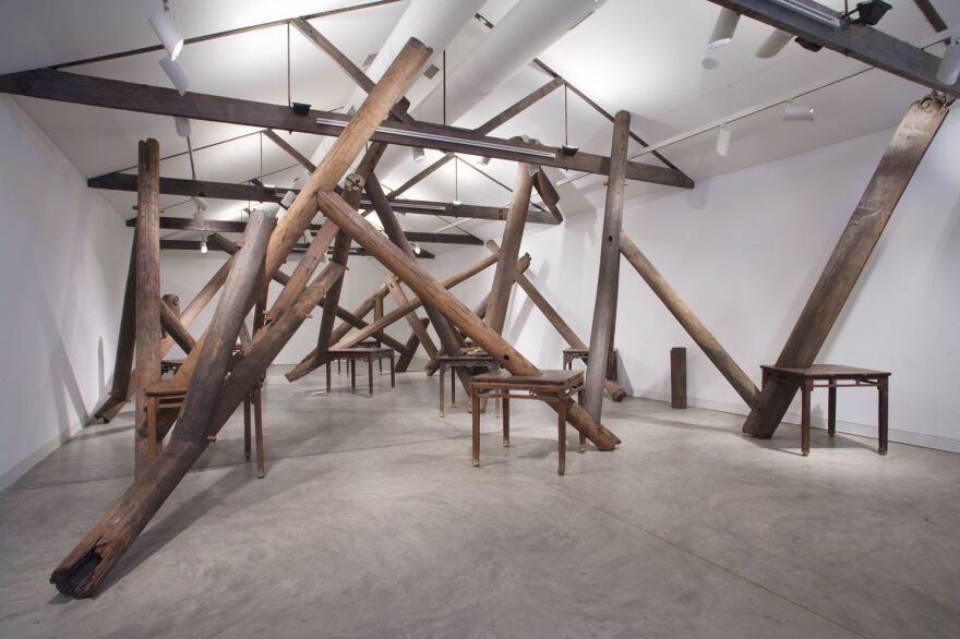 This piece called Through, 2007-2008, employs tables, beams and pillars from dismantled temples of the Qing Dynasty.