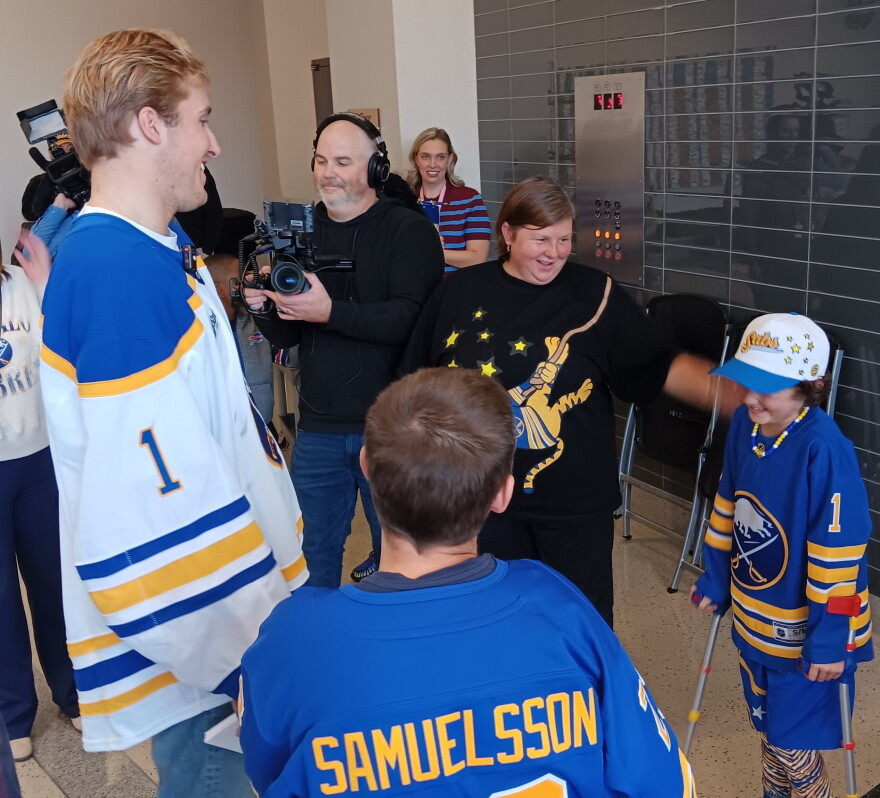 Buffalo Sabres goaltender Ukko-Pekka Luukkonen meets with a young fan