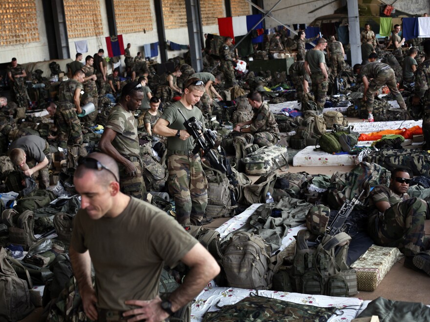 French troops gather in a hangar at Mali's Bamako airport. French forces led an all-night aerial bombing campaign against armed Islamist extremists Tuesday.