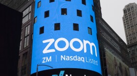 A sign for Zoom Video Communications is pictured ahead of the company's Nasdaq IPO in New York in 2019. The company has agreed to a preliminary settlement in a privacy lawsuit.