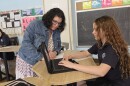 Saint John Neumann teacher Terra Thomke works with students at the Williamsport school on Thursday. Starting in the fall, students won't have class on Fridays.