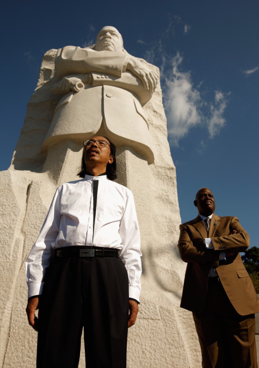 Master Sculptor Lei Yixin and Harry Johnson, president and CEO of the Martin Luther King Jr. National Memorial Project Foundation, stand at the base of the 30-feet-tall sculpture at the new King memorial.