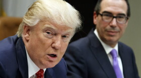 Treasury Secretary Steven Mnuchin listens as President Trump speaks during a meeting on the Federal budget at the White House in February 2017. (Evan Vucci/AP)