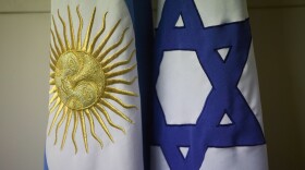 An Argentine and Israeli flag stand side by side at the office of Guillermo Borger, president of the Jewish community center AMIA