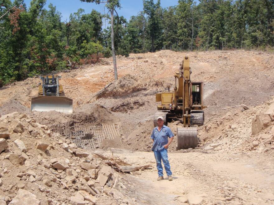 Jimmy Watson stands in front of what will be the opening to the mine.