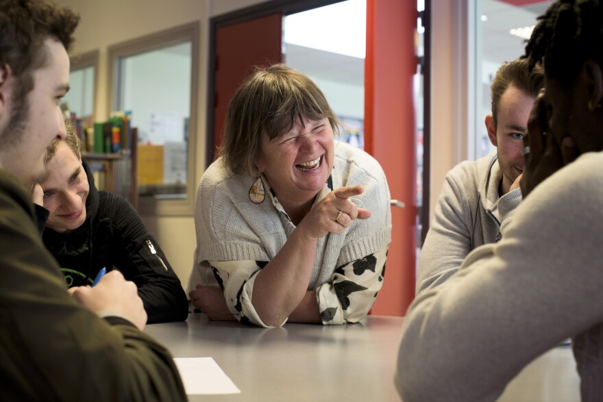 French and history/geography teacher Corinne O'Miel laughs with her students while helping them to create a conspiracy theory involving Kim Kardashian, bus drivers and Wi-Fi.