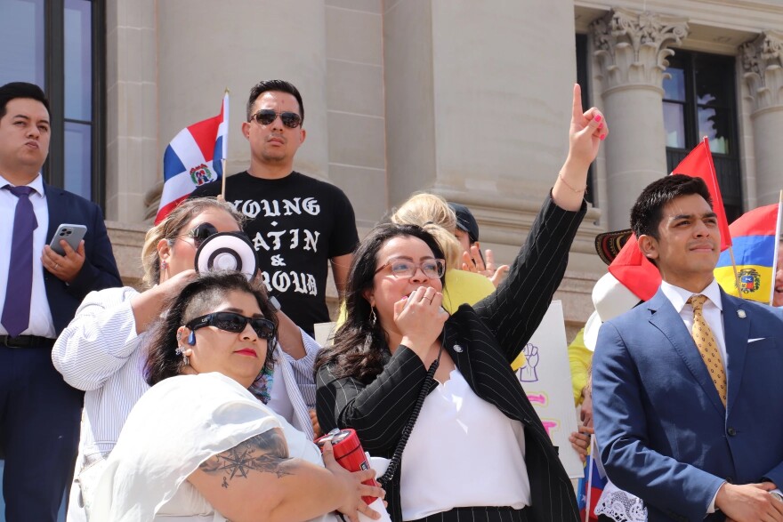 Activist Angelica Villalobos holds a megaphone for Rep. Annie Menz while the Norman Democrat gives a speech to demonstrators protesting HB 4156 outside the Oklahoma State Capitol April 23, 2024. Rep. Arturo Alonso-Sandoval stands to the left of Menz, looking to the crowd.