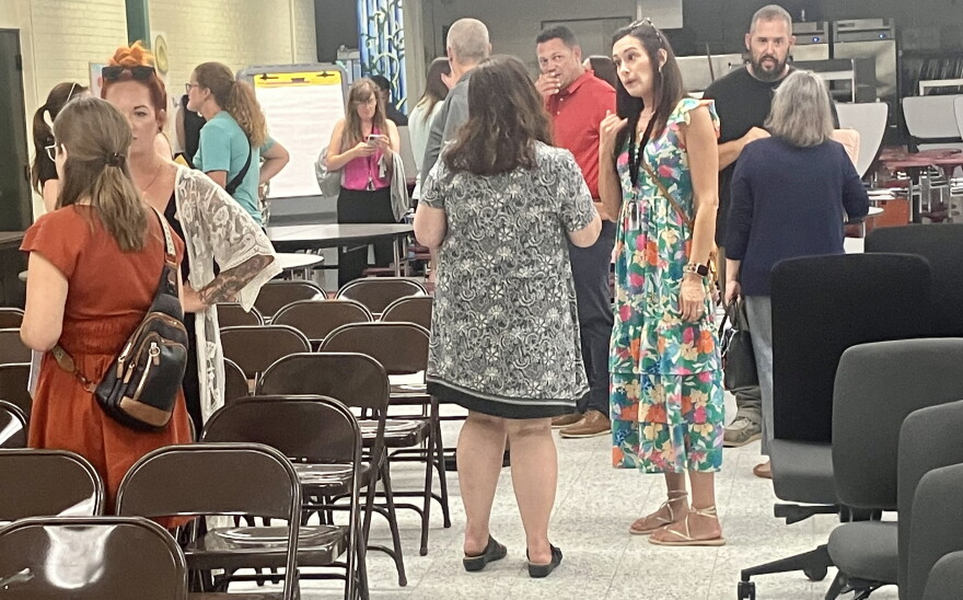 Parents of Pekin District 108 students chat Monday after a special school board meeting in the Washington Intermediate School cafeteria.
