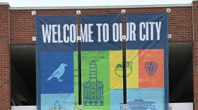 A "Welcome to our city" banner hangs from the side of a parking garage in downtown Springfield, Ohio.