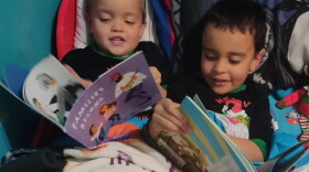 Ashley McNair's sons Kenny Jr., then 3, and Matteo, then 5, read books they received from the Rochester Imagination Library in this 2022 file photo.