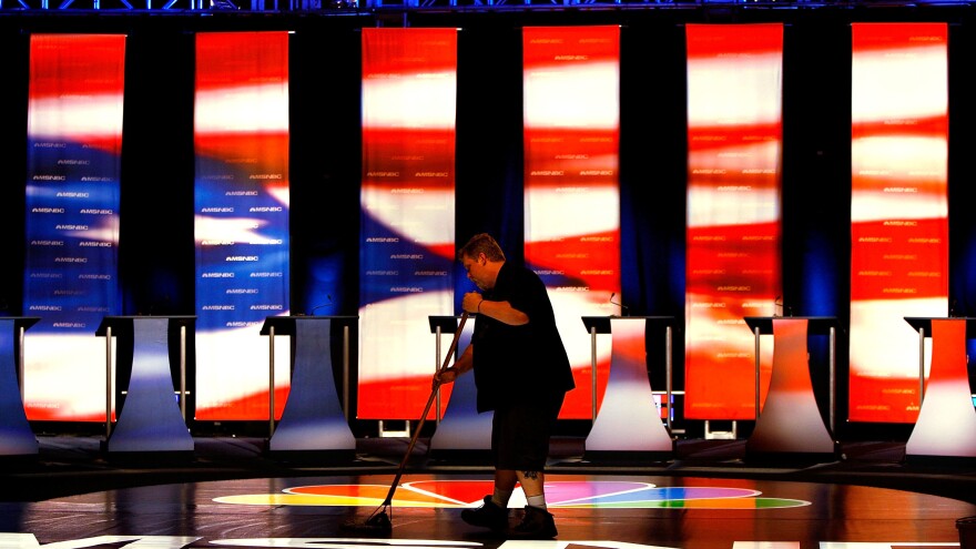 A worker sweeps the stage prior to the first Democratic presidential debate on April 26, 2007, in Orangeburg, S.C. The debate featured eight Democratic presidential candidates.