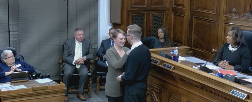 Fran Wilson (left) is pinned by his sister, Joan, ahead of Akron City Council's meeting on Dec. 1, 2025.