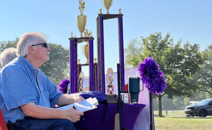 A judge sits aside the Miss Annie Oakley trophy.