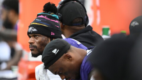 Baltimore Ravens quarterback Lamar Jackson, left, looks out from the bench during the second half of an NFL football game against the Tennessee Titans in Baltimore, Sunday, Oct. 4, 2026. (AP Photo/Nick Wass)