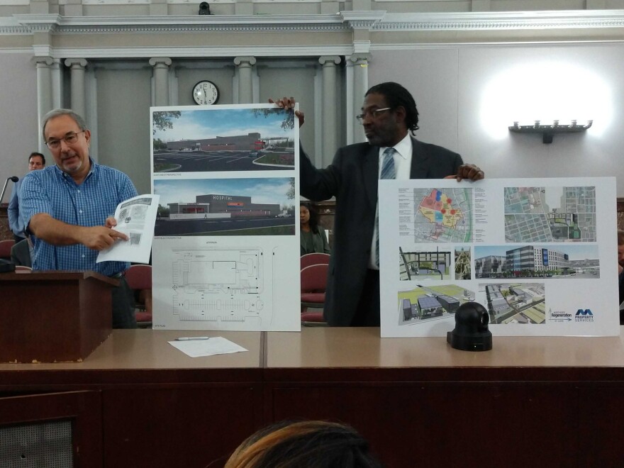 Bill Laskowsky (left) and Darryl Piggee, representatives of the Northside Regeneration urgent care project, show renderings for the proposal.
