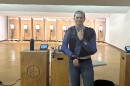 Jadon Nafziger stand in a gun range with targets and air rifle behind him.