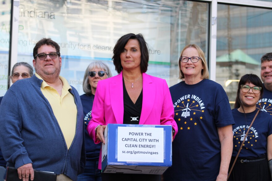 AES Director of Public Relations Kelly Young accepted petitions from activists calling the company to move to clean energy