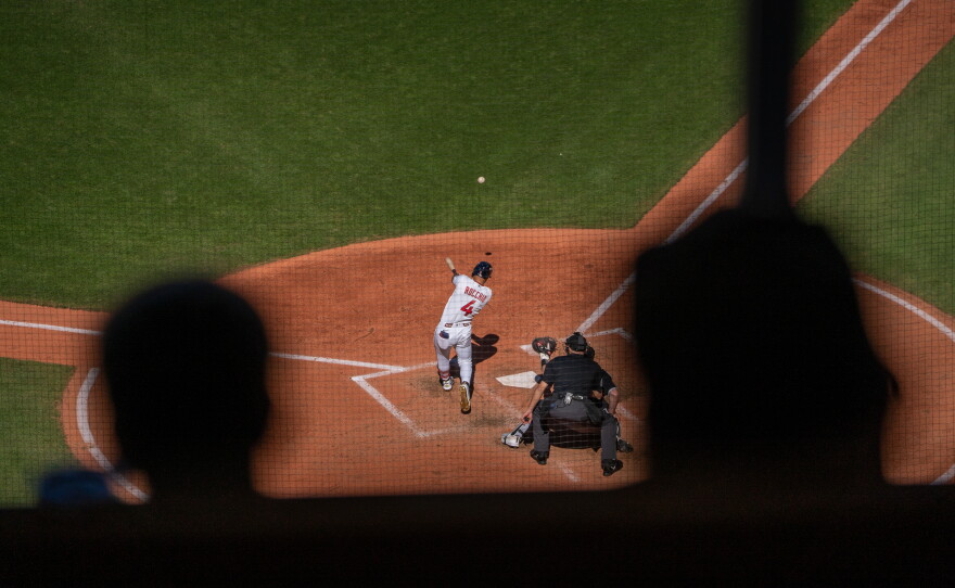 baseball player hitting ball.